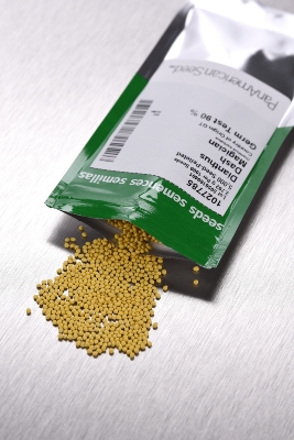 Pelleted seeds coming out of a packet on a table